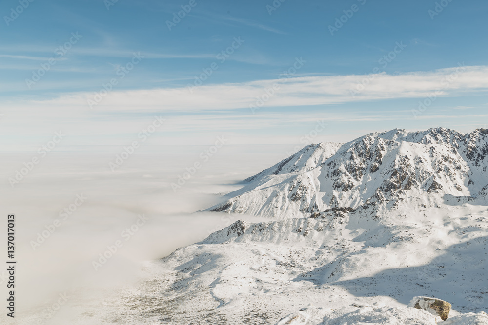 Spectacular winter landscape. Mountains surrounded by low cloud Spectacular winter landscape. Mountains surrounded by low cloud