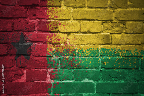 painted national flag of guinea bissau on a brick wall
