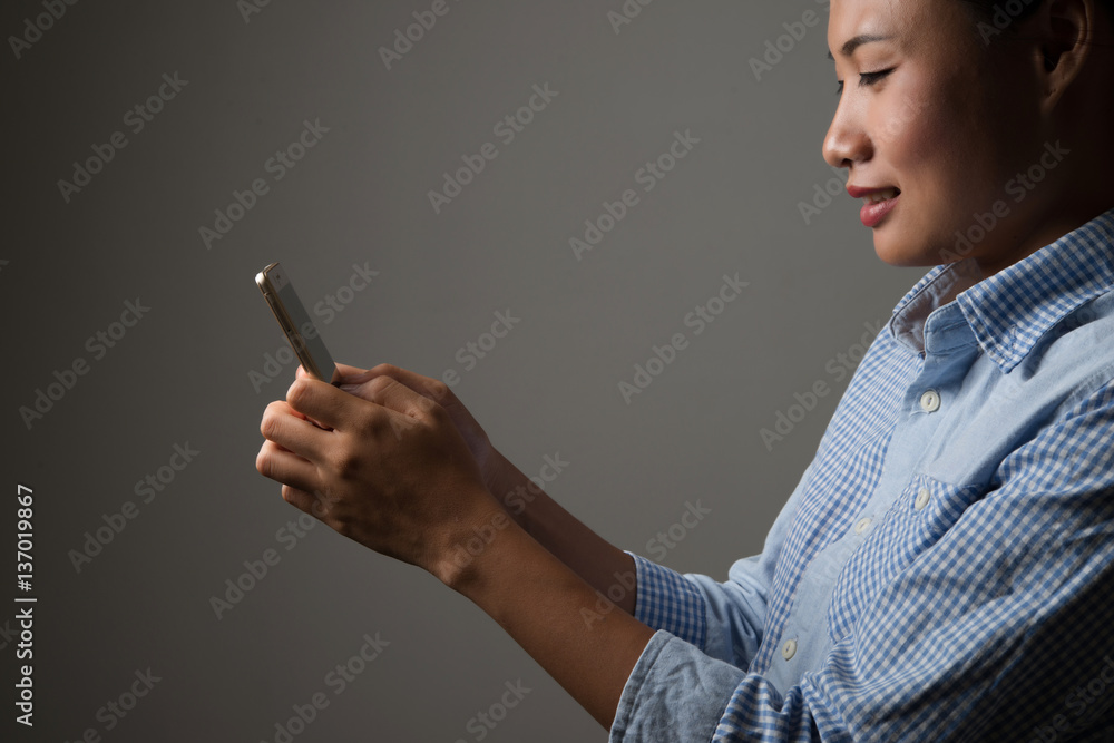 Handsome hipster man smiling while using smartphone on white background. Handsome hipster man smiling while using smartphone on white background.