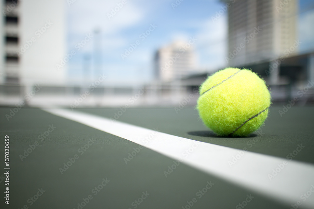 Tennis ball on green tennis hard court