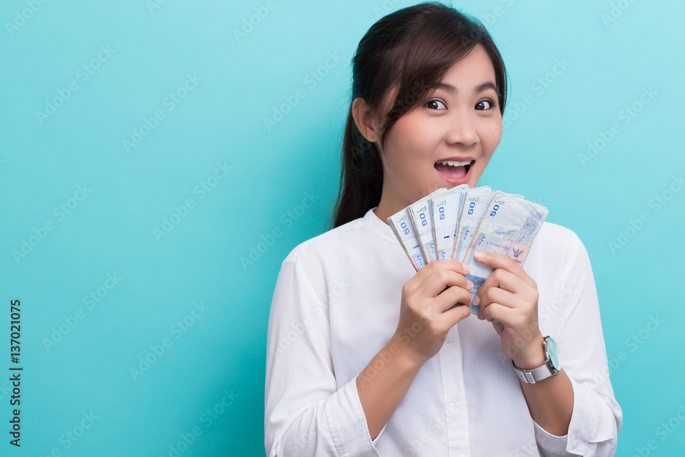 Asian woman happy saving fifty baht banknote Asian woman happy saving fifty baht banknote