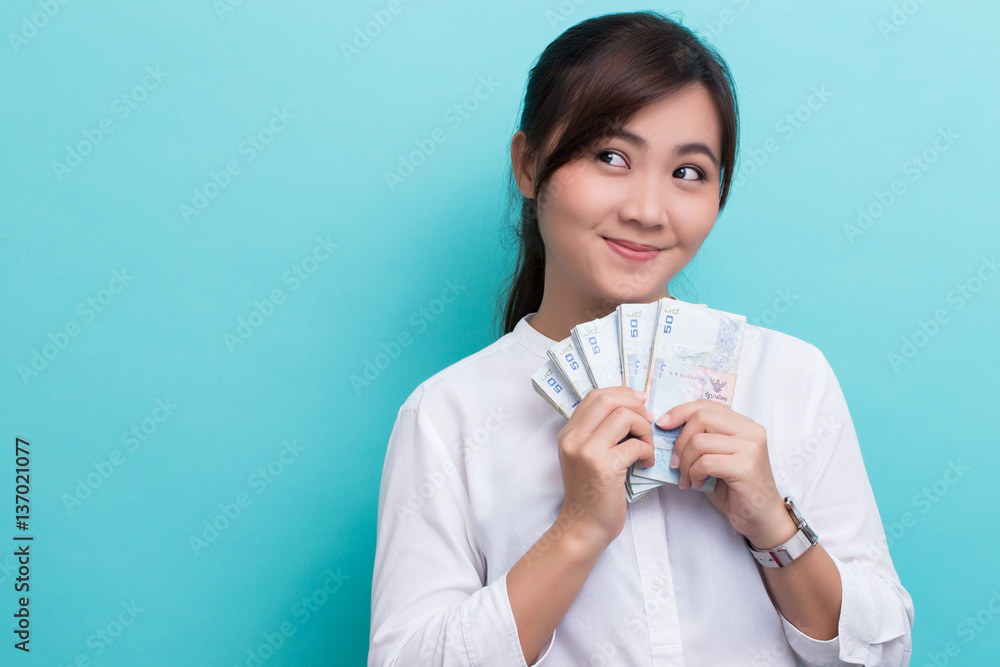 Asian woman happy saving fifty baht banknote Asian woman happy saving fifty baht banknote