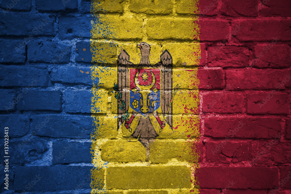 Fototapeta premium painted national flag of moldova on a brick wall