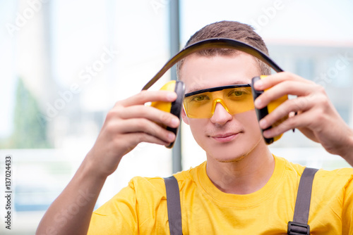 Wallpaper Mural Young construction worker in yellow coveralls Torontodigital.ca