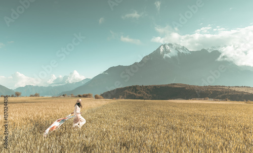 Girl running through the wheat farm photo