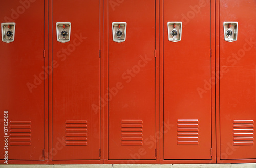 close up on red lockers in gym