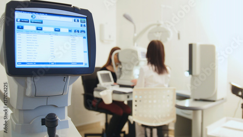 Health care equipment concept - doctor ophthalmologist in eyes clinic working with patient by modern computer technology