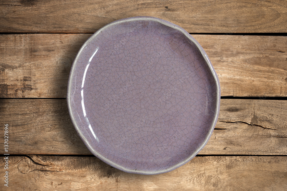 Top view of blank dish on a wood background. Top view of blank dish on a wood background.
