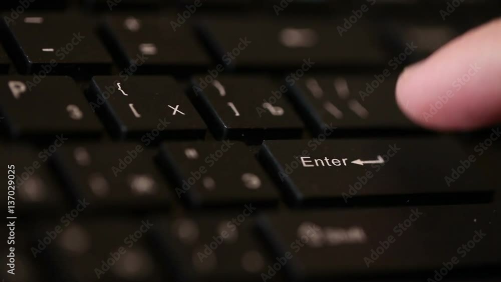 man presses the black button enter. Macro shooting man presses the black button enter. Macro shooting