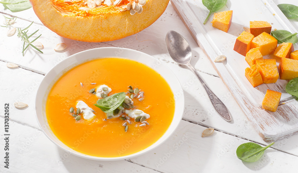 Pumpkin soup on white wooden background. Pumpkin soup on white wooden background.