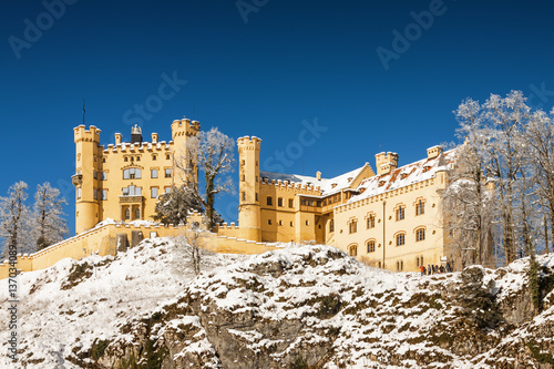 Fotografie Snowy Bavarian Alps and Hoshenschwangau castle at foggy morning, Bavaria, Germany