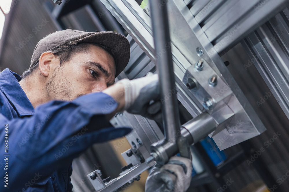 Attentive worker looking at details Attentive worker looking at details