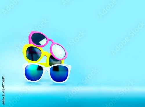Stack of Sunglasses in light blue studio,Summer Time concept,Le