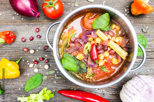 Mexican Cuisine. Bio Vegetable Soup with Chickpea and Adzuki Beans in Pot with Cooking Ingredients on Wooden Table Background