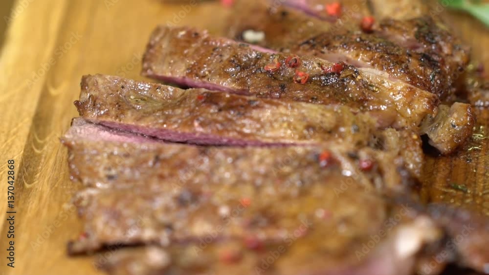 Big steak sliced and served on a wooden board Big steak sliced and served on a wooden board