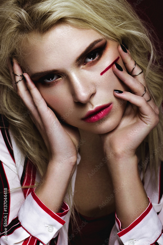Obraz premium Beautiful girl with art make up in white striped shirt. beauty face. Photos shot in studio