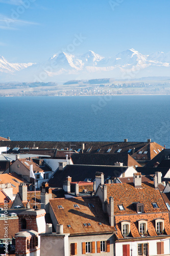 Top view of the medieval town of Neuchatel in Switzerland, on the horizon can be seen the lake and the Bernese Alps Chaumont. photo