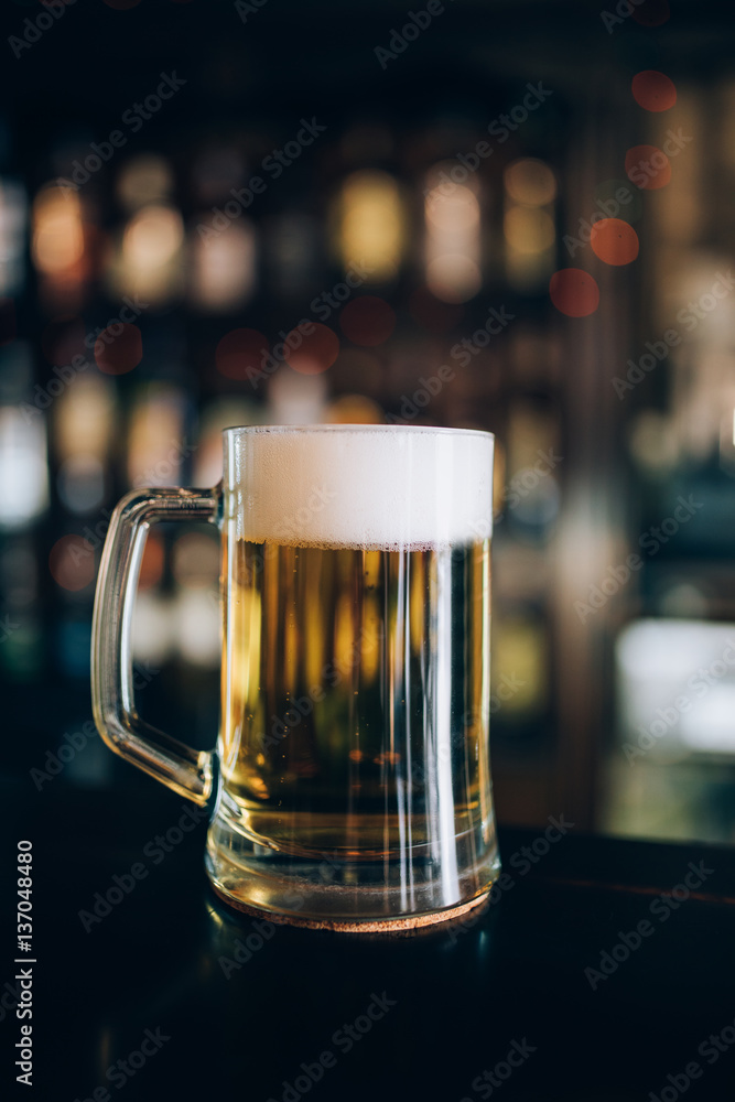 One glass of beers on a pub background. One glass of beers on a pub background.
