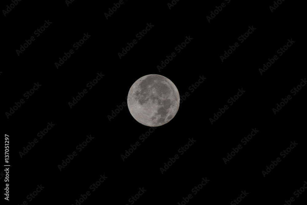 Full moon on the dark night. Full moon over dark black sky at night. Full moon on the dark night. Full moon over dark black sky at night.