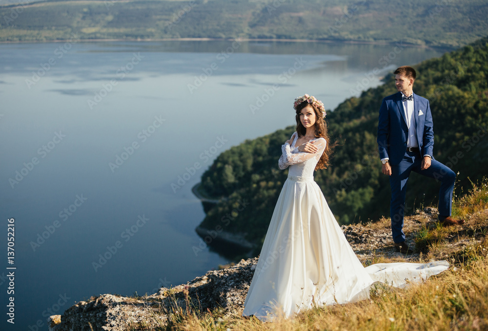 Couple in love standing on the hillside