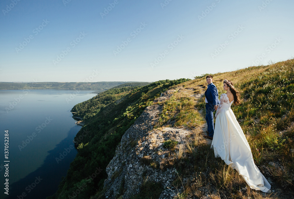 Couple in love standing on the hillside