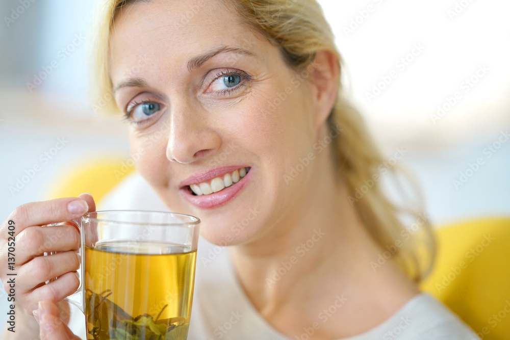 Portrait of blond woman drinking plants infusion Portrait of blond woman drinking plants infusion