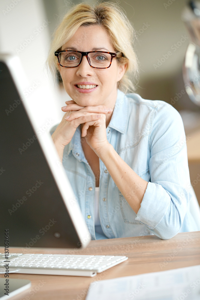 Businesswoman in office working on desktop computer Businesswoman in office working on desktop computer