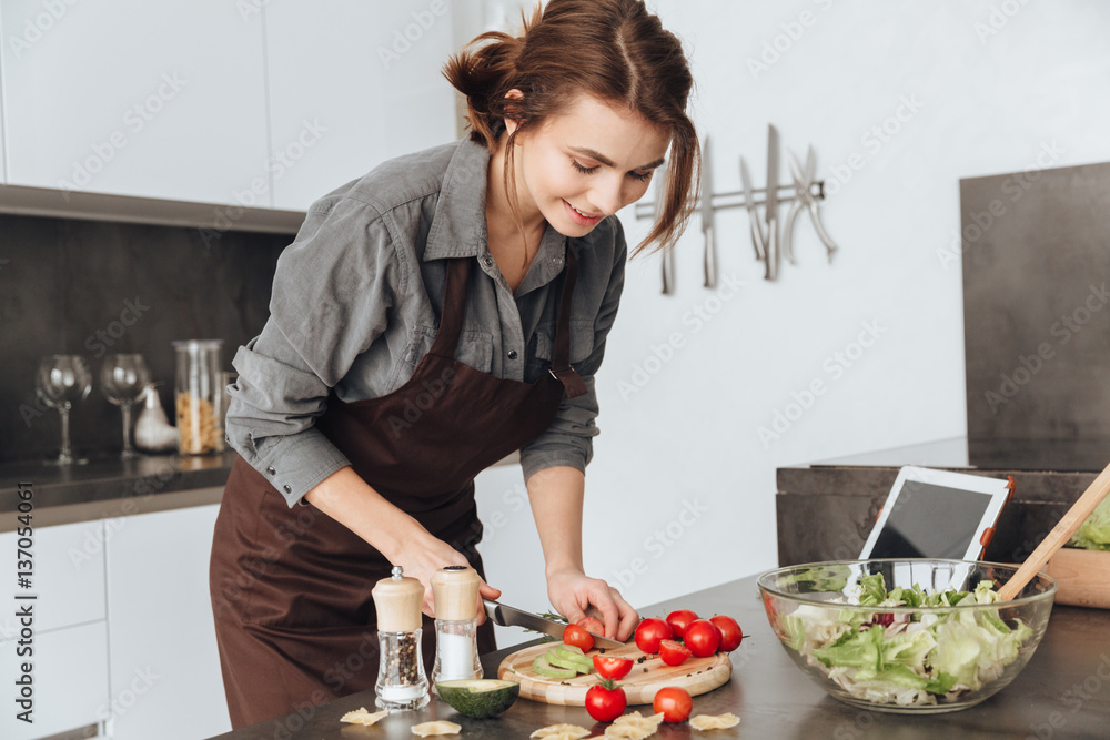 Incredible lady using tablet and cooking Incredible lady using tablet and cooking