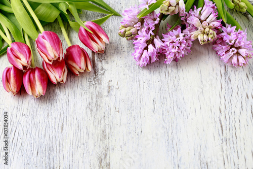 Tulips and hyacinths on wooden background