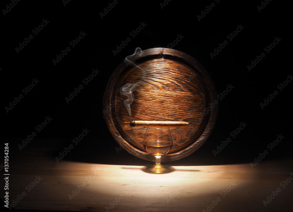 Glass of Cognac , Cigar and old oak barrel