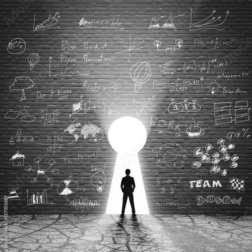 Rear view of a business man against the  door exit of the room
