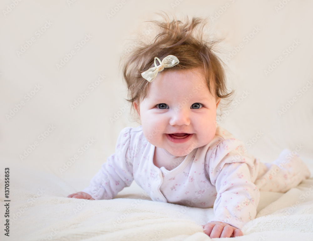 A small child laughing and learning to crawl. A small child laughing and learning to crawl.