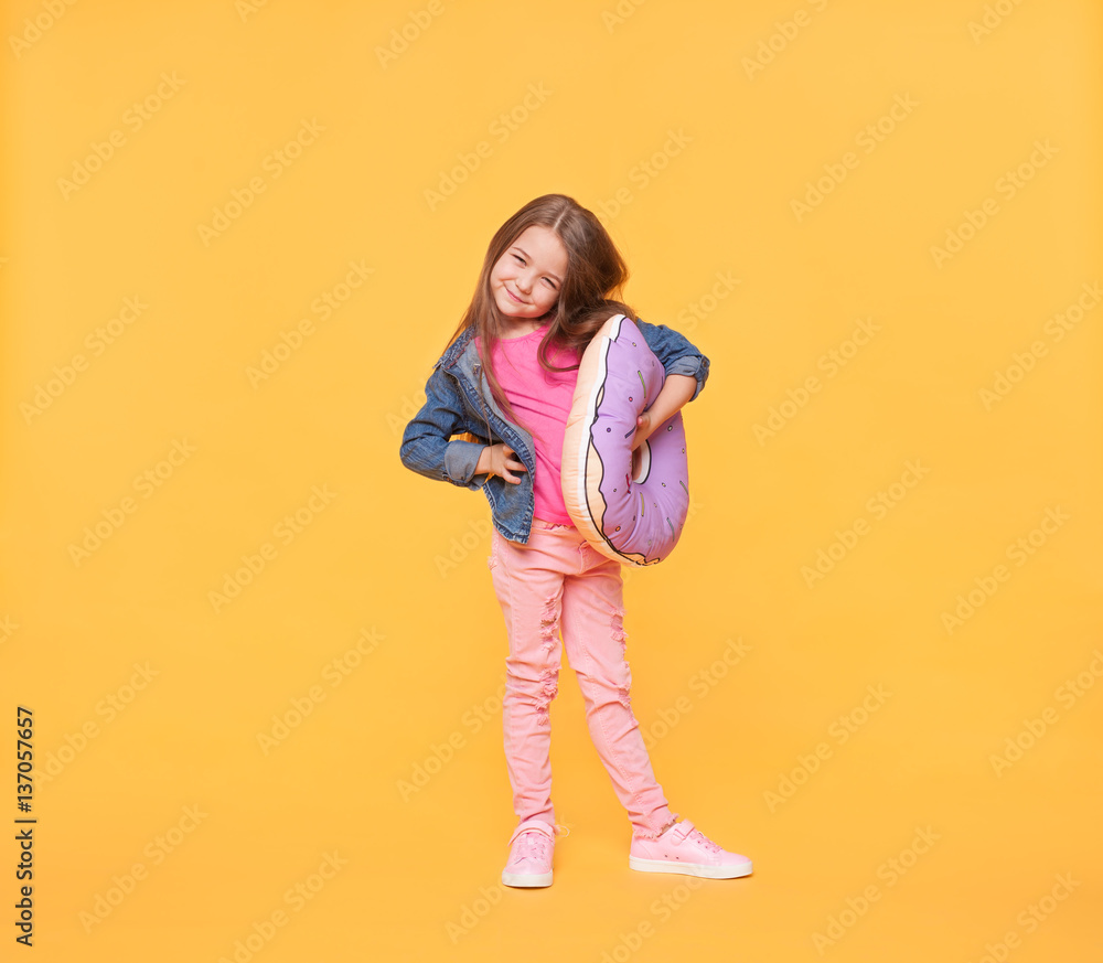 little girl is hugging a pillow and looking at camera little girl is hugging a pillow and looking at camera