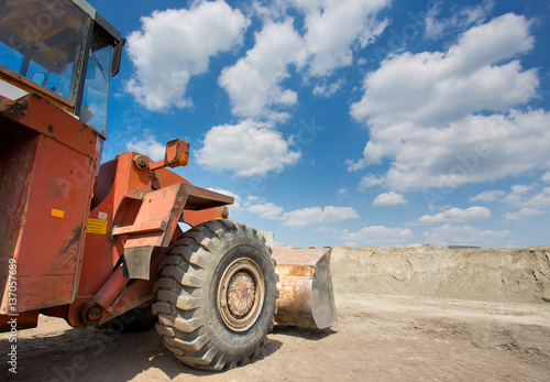 Bulldozer in front of sand pile