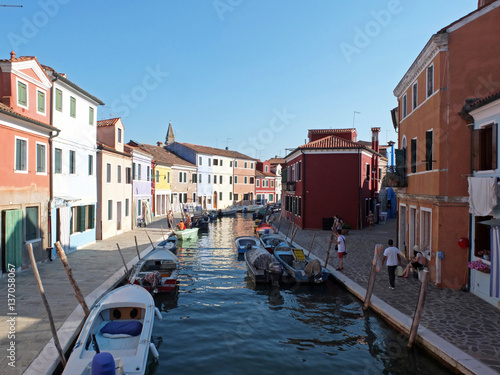 This photo shows one of the channels of the island Burano and multicolored houses in quays.