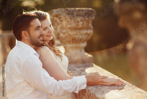 The happinest  brides embracing near castle photo