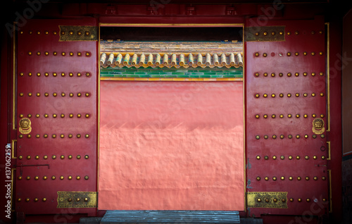 Ancient red wooden doors at the Forbidden City, Beijing