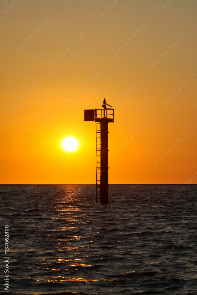 Sunset over the Sea of Carpentaria with a signal tower, Karumba, Queensland, Australia Sunset over the Sea of Carpentaria with a signal tower, Karumba, Queensland, Australia