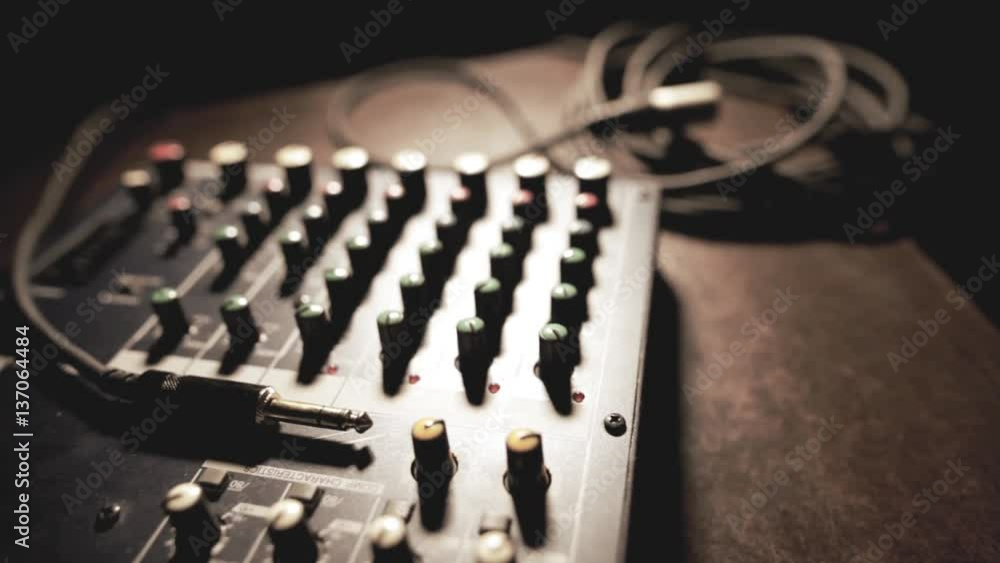 Dolly shot of a mixer desk with many buttons and cables. Dolly shot of a mixer desk with many buttons and cables.
