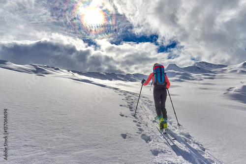 Uphill girl with seal skins and ski mountaineering photo