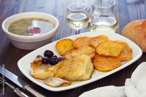 fried cod fish with potato on white dish