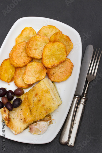 fried cod fish with potato on white dish