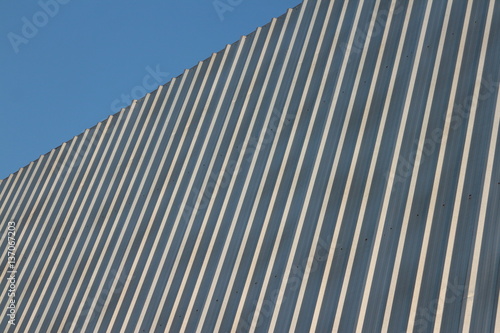 Blank corrugated metal advertising hoarding with blue sky in corner.blue sky.