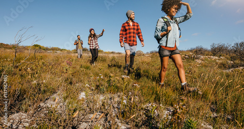 Young friends hiking in countryside photo