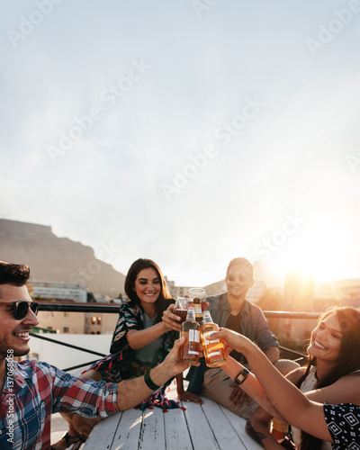 Canvas Print People celebrating with drinks at rooftop party