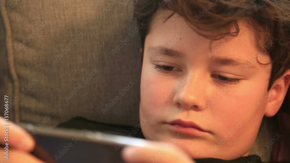 Child using mobil phone in home. Smartphone addiction Child using mobil phone in home. Smartphone addiction
