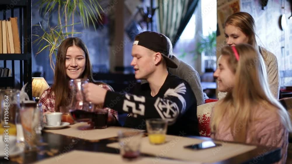 Cheerful teenagers relaxing at coffee shop. Cheerful teenagers relaxing at coffee shop.