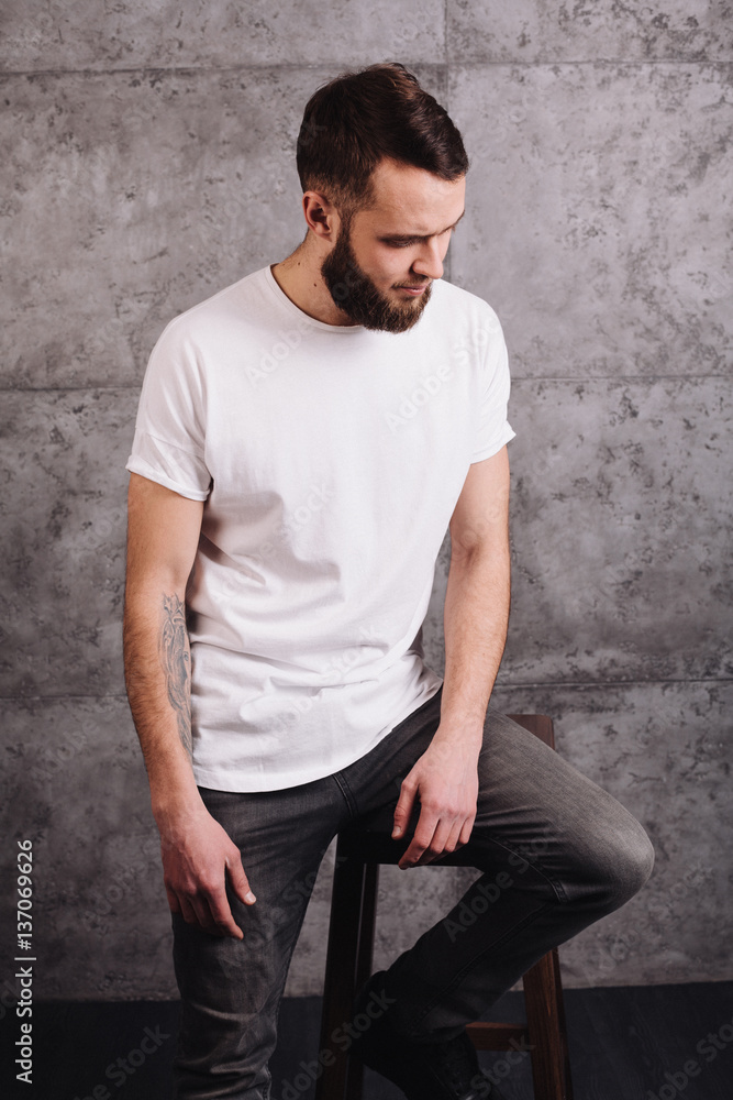Man wearing white blank t-shirt with space for your logo Man wearing white blank t-shirt with space for your logo