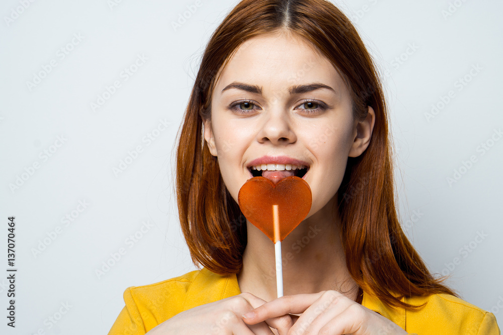 happy woman with a lollipop on a stick, heart happy woman with a lollipop on a stick, heart