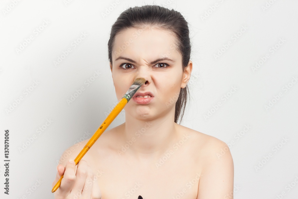 nude brunette titillating with nose brush nude brunette titillating with nose brush